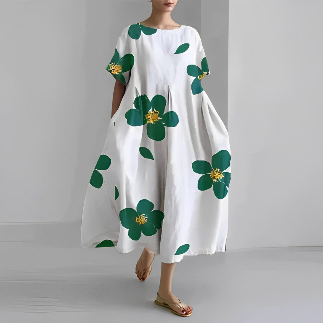 Comfortable relaxed fit women's midi dress featuring a vibrant artistic print, short sleeves, and pockets.