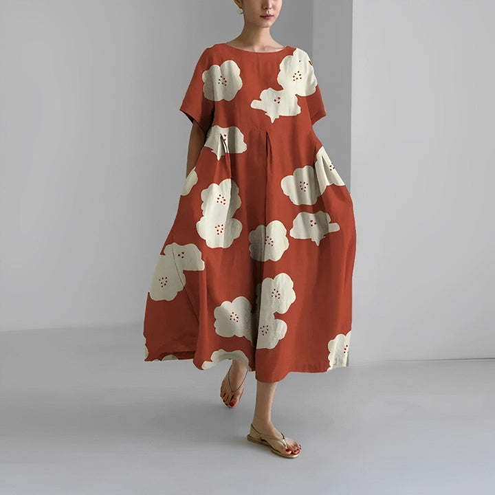 Vibrant artistic print midi dress for women, relaxed fit, short sleeves, round neck, and functional pockets.