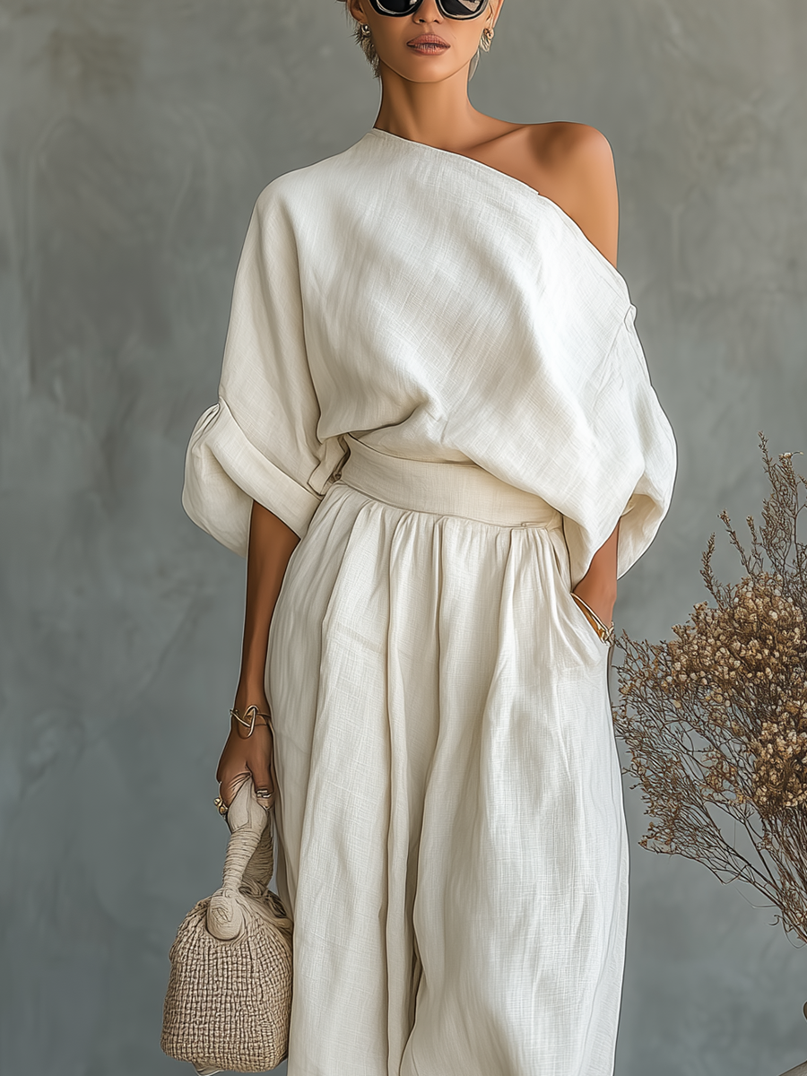 Chic coordinated women's set with a flowing asymmetric top and wide leg pants, ideal for summer fashion.