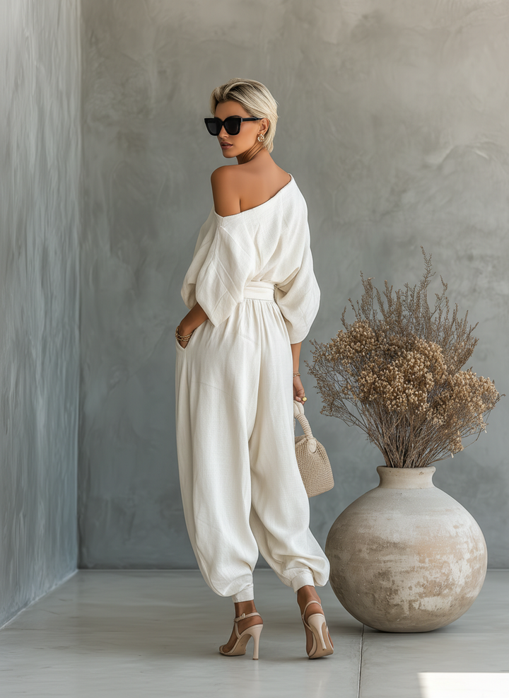 Modern women's two-piece set: an elegant asymmetric drape top paired with comfortable wide leg pants.