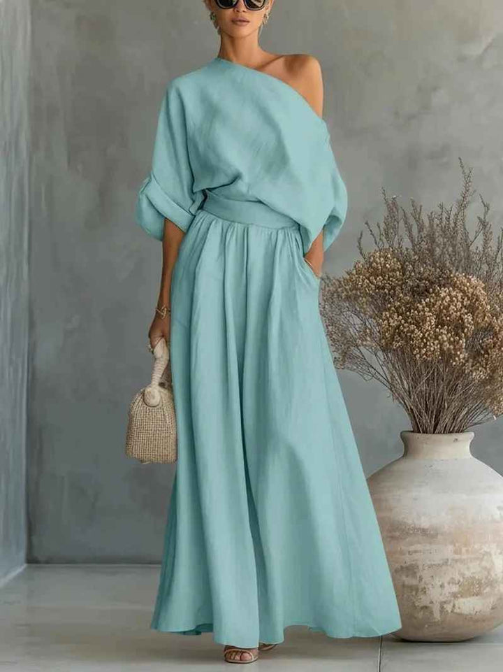 Comfortable women's two-piece set featuring an asymmetric drape top and wide leg pants, great for travel.