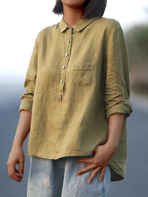 Full shot of a model wearing a women's asymmetrical hem button-up blouse, showcasing its effortless casual style.