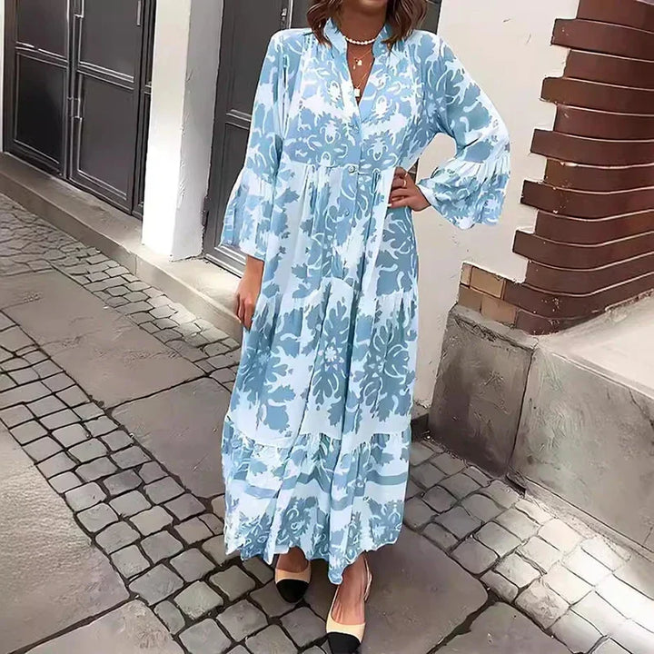 Elegant women's tiered boho maxi dress featuring a vibrant baroque print and stylish long lantern sleeves.