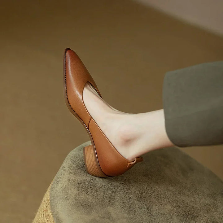Professional women's beige court shoes with pointed toe & mid block heel, perfect for office elegance.
