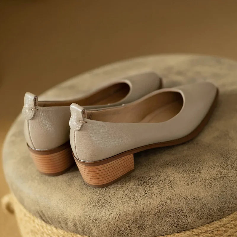 Front view of elegant women's pointed toe slip-on court shoes, ideal for versatile styling & comfort.