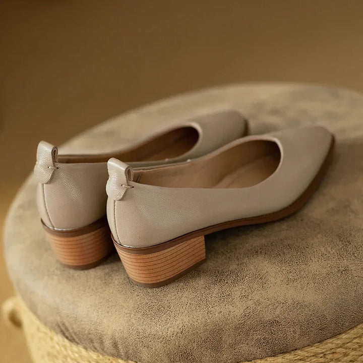 Front view of elegant women's pointed toe slip-on court shoes, ideal for versatile styling & comfort.