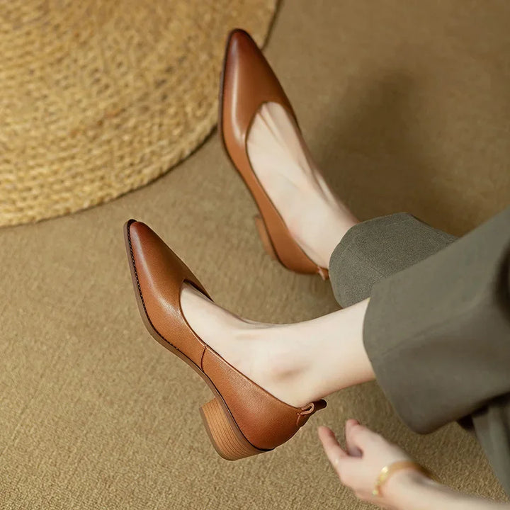 Close-up of the sophisticated pointed toe on women's slip-on court shoes, chic and professional.
