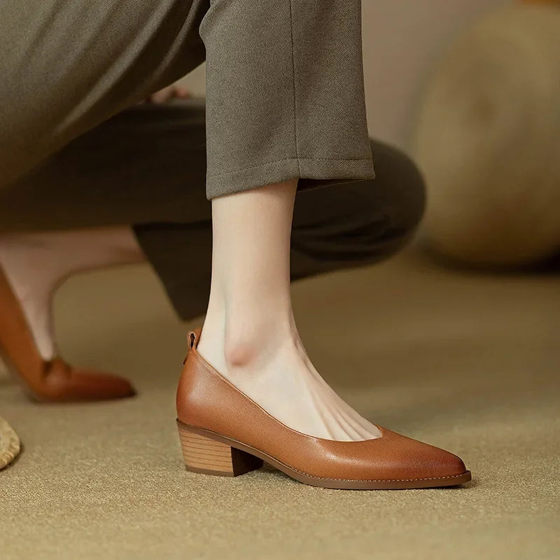 Detail of the comfortable mid block heel on versatile women's court shoes, stable & elegant design.