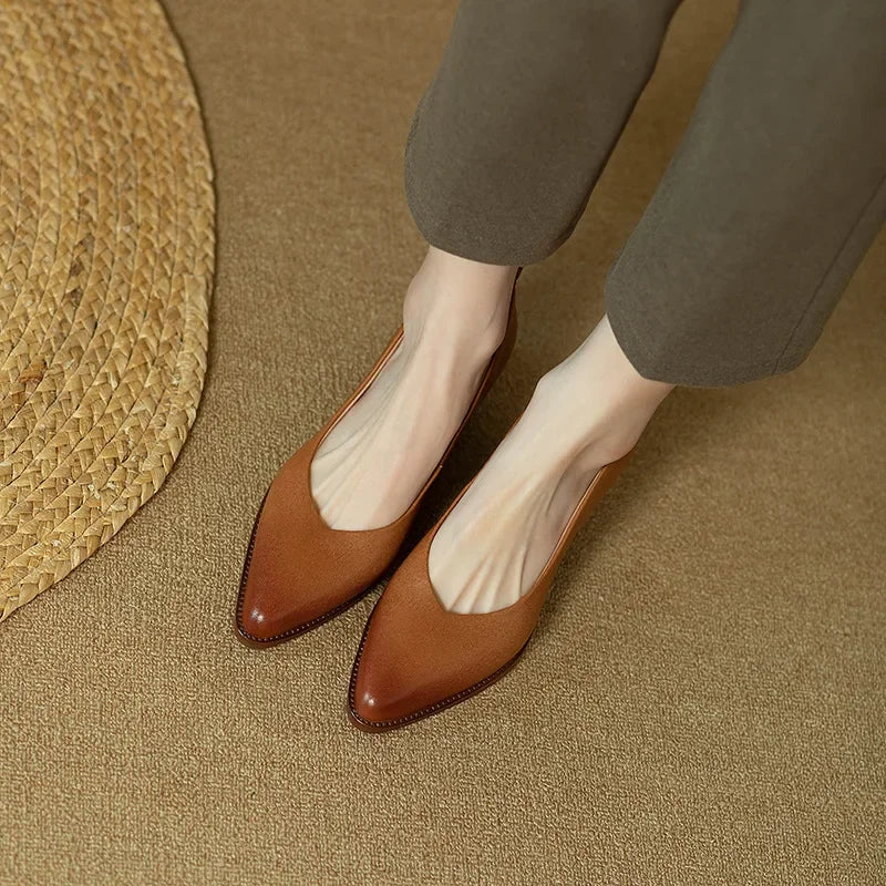 Women's pointed toe slip-on court shoes with mid block heel on foot, demonstrating elegant fit & comfort.