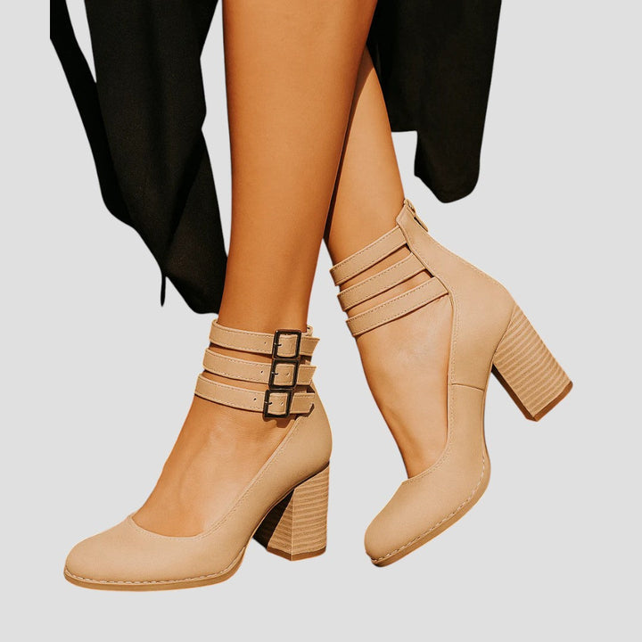 Modern women's block heels with a closed toe and chic buckle strap. Elegant, comfortable, versatile footwear.
