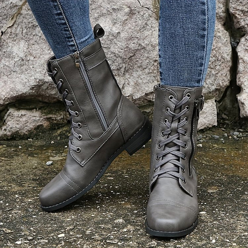 Women's combat boots on a snowy path, showcasing their durability and suitability as winter boots.