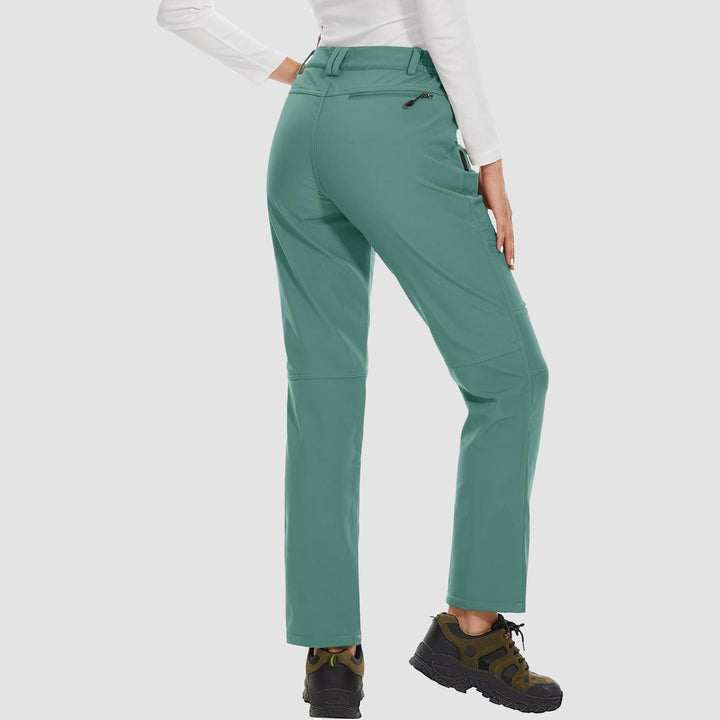 Women's protective black softshell pants with fleece lining, ideal for cold weather hiking