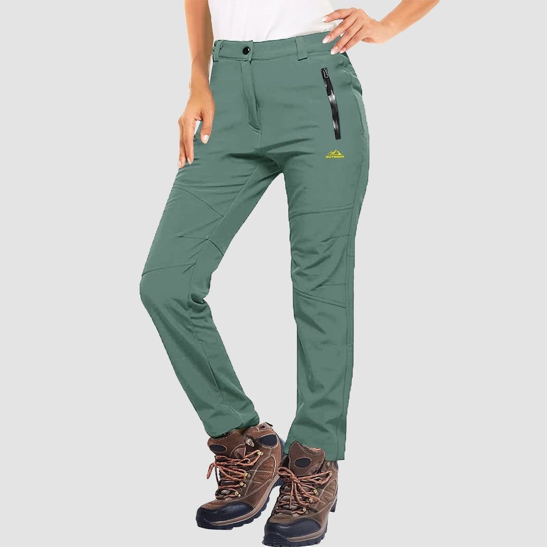 Side view of women's stretch softshell pants in blue, perfect for hiking and skiing
