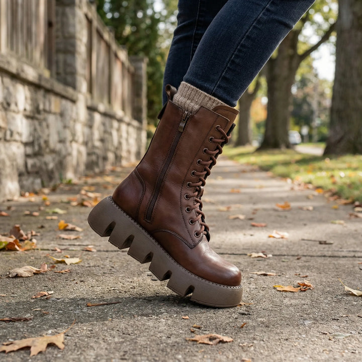 Women's black lace-up platform combat boots with arch support for comfortable, edgy everyday wear.