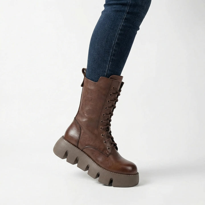 Durable women's ankle combat boots with arch support, lace-up closure, and platform for comfortable winter fashion.