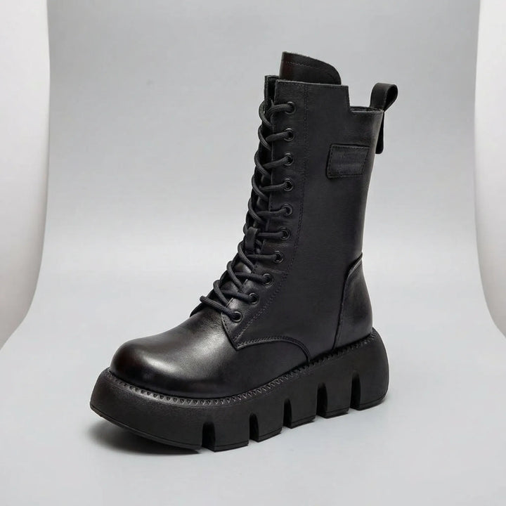 Front view of women's black combat boots with comfortable arch support, non-slip platform, and stylish lace-up.