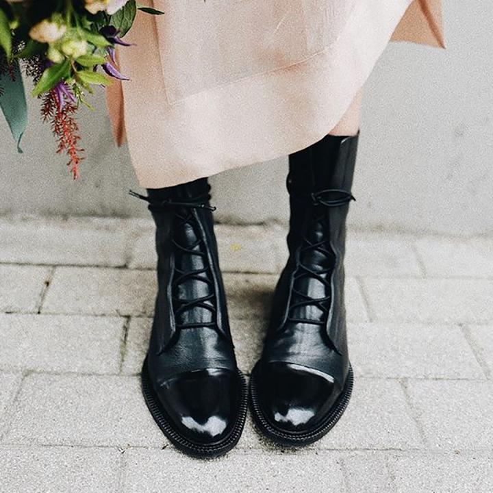 Stylish women's leather ankle boots, lace-up front & sturdy sole for lasting comfort.