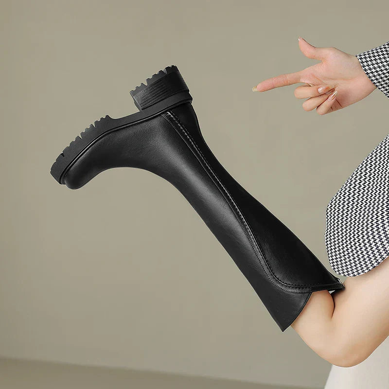 Pair of women's orthopedic leather boots, black, showing sturdy sole and comfortable design