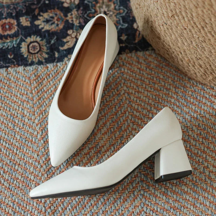 Elegant women's pointed toe pumps with comfortable block heels for professional office wear.