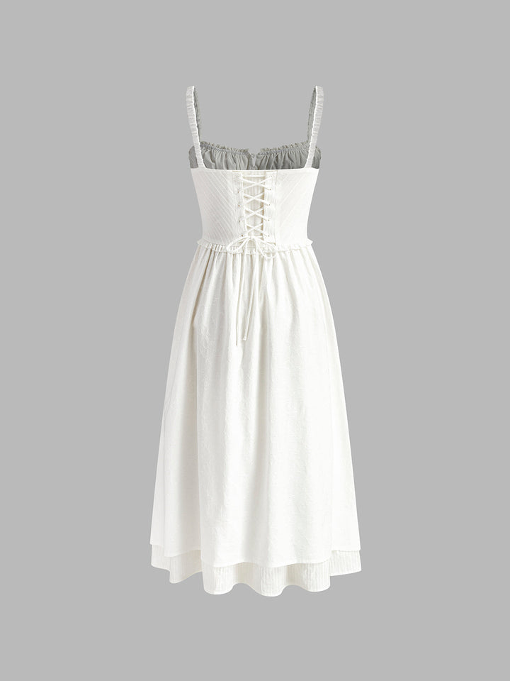 Women's black sleeveless cami midi dress with a flowing ruffle hem, ideal for elegant wear.