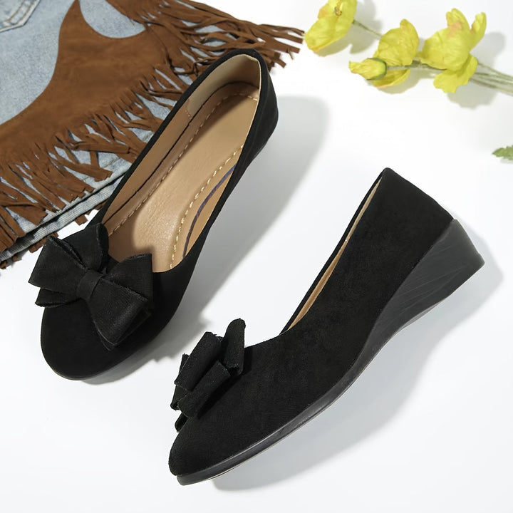 Comfortable women's dress flats, wedge heel and bow detail for versatile style.