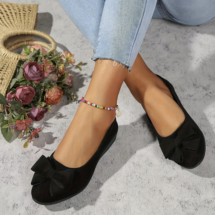 Chic women's slip-on ballet flats with a graceful bow and walkable wedge.