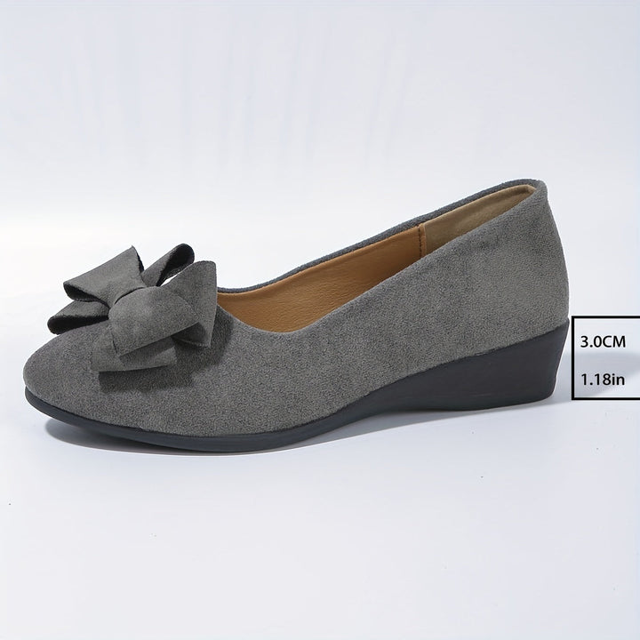 Women's casual elegant flats; round toe, bow detail, comfortable wedge.