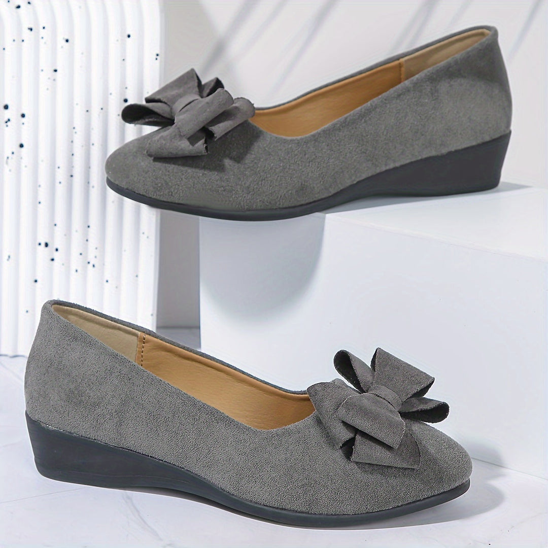Women's comfortable walking flats, wedge heel, round toe, and pretty bow.