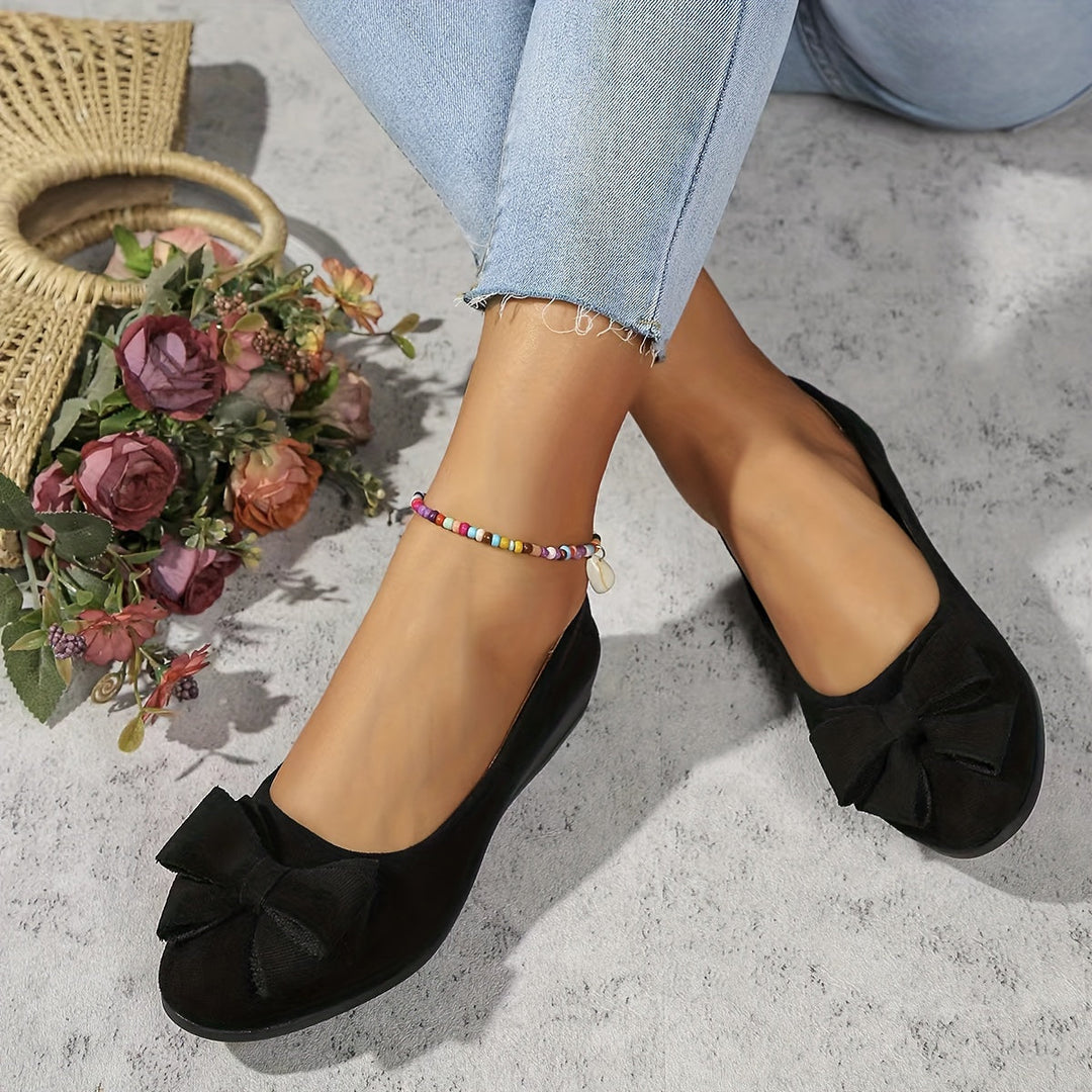 Versatile women's wedge flats, ideal for casual or dressy looks, bow detail.