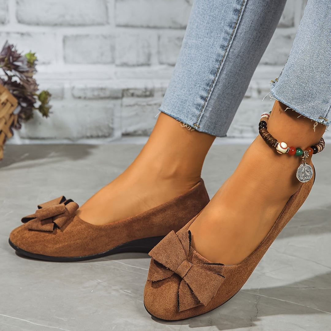 Stylish women's round toe flats, slip-on comfort, subtle wedge, pretty bow.