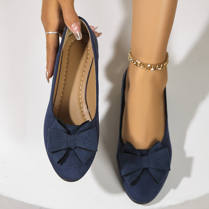 Everyday wear women's flats; classic round toe, subtle wedge, pretty bow.
