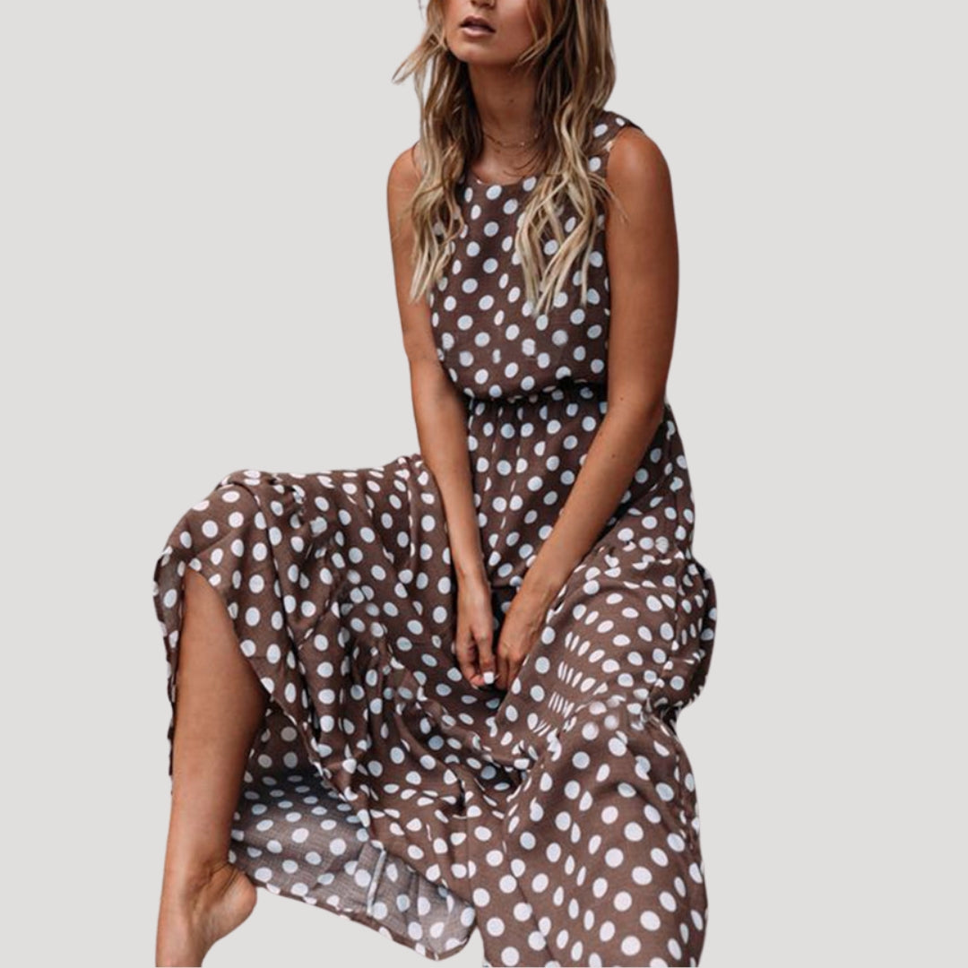 Women's black & white polka dot sleeveless midi A-line dress with a round neck. Perfect for summer casual.