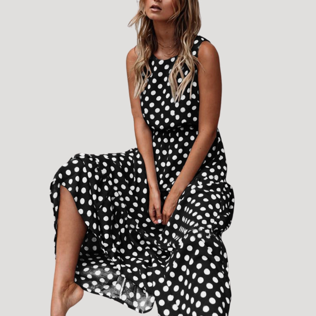 Elegant women's polka dot midi dress, sleeveless A-line, round neck. Ideal for versatile vacation or summer style.