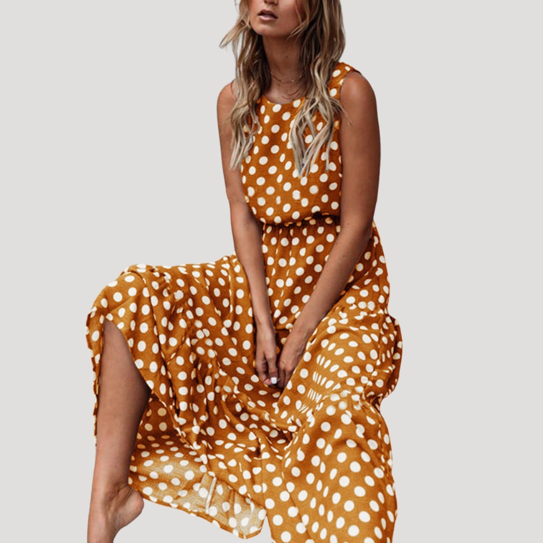 Comfortable women's polka dot sleeveless A-line midi dress. Features a stylish round neck, great for everyday wear.