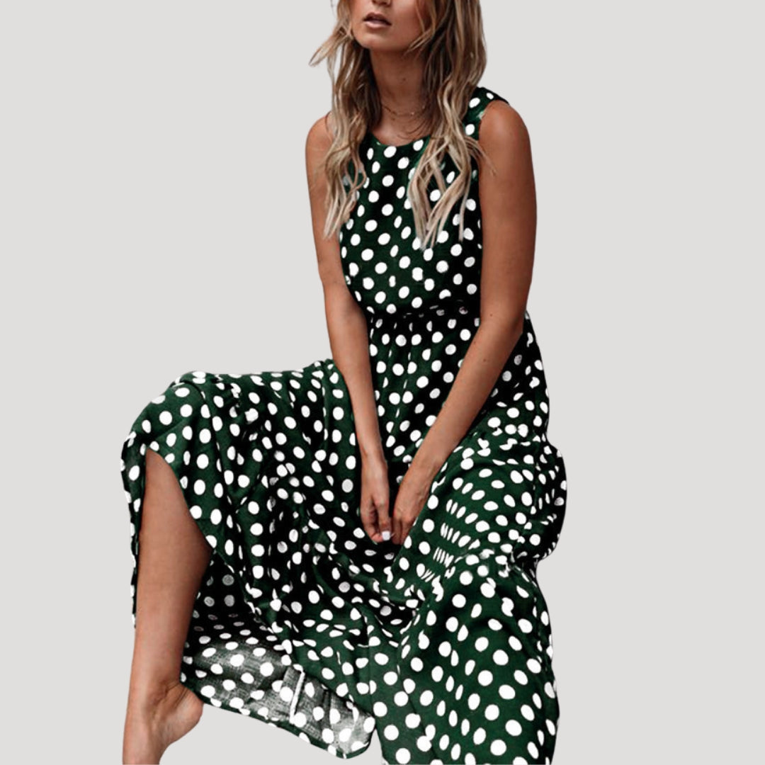 Fashionable women's polka dot sleeveless midi dress, A-line cut, round neck. A versatile choice for casual & elegant looks.