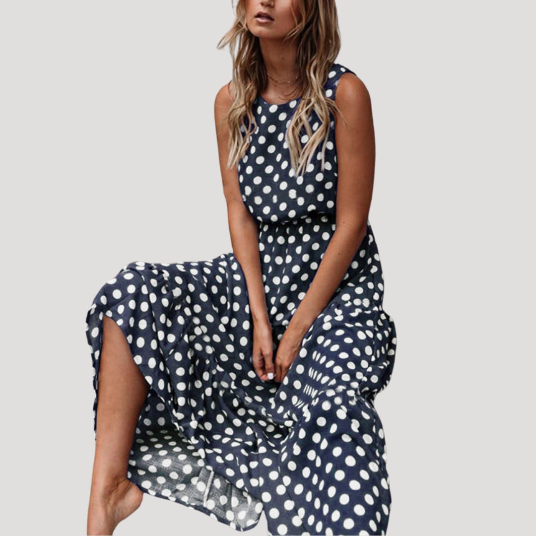 Classic women's polka dot sleeveless round neck A-line midi dress. Chic summer fashion, perfect for any occasion.
