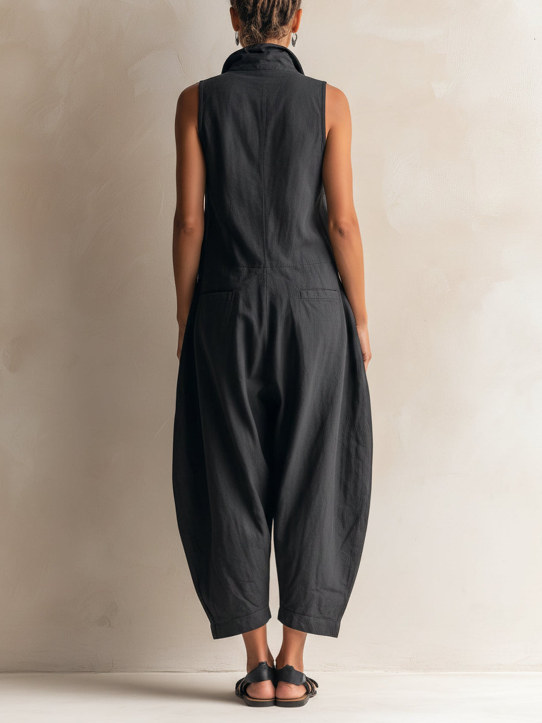 Effortless black wide-leg jumpsuit for women, featuring a stylish collar & sleeveless design, ideal for summer comfort.