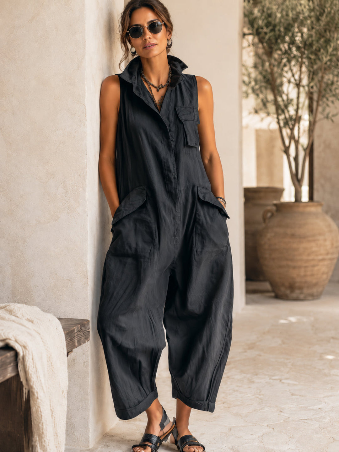 Elegant women's black wide-leg jumpsuit, sleeveless with a smart collar. Perfect for a comfortable yet chic everyday look.