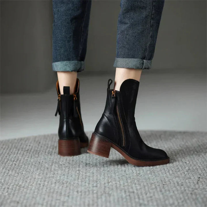 Fashionable women's zip-up boots featuring a sturdy block heel, making them versatile ankle footwear.