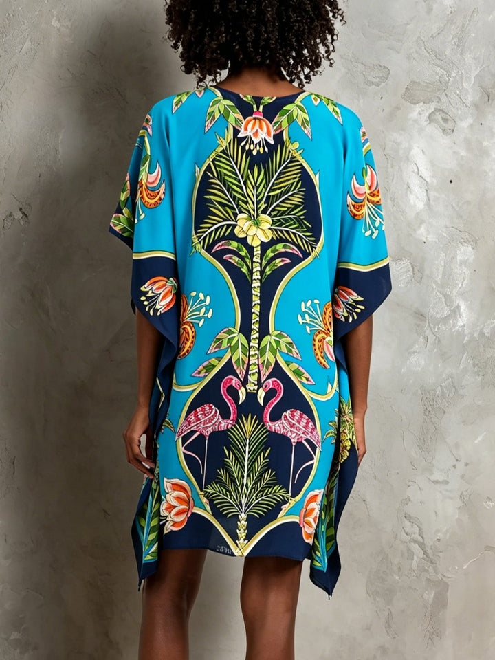 Flowy blue tropical print midi dress for women, ideal as resort wear or a stylish summer vacation dress.
