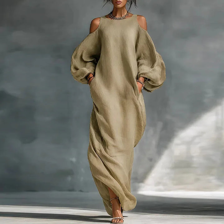 Elegant flowing bohemian maxi dress for women, featuring a stylish cold shoulder design and long sleeves.