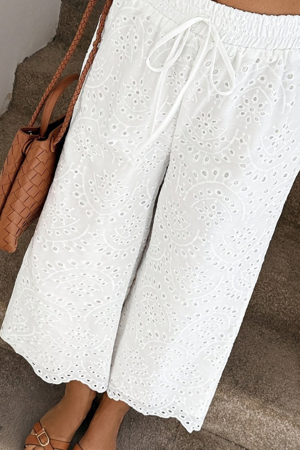 Eyelet bohemian cropped pants for women, offering a relaxed fit for summer vacations.