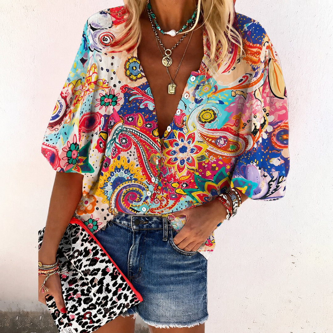Stylish women's floral v-neck blouse. A relaxed fit, short sleeve, button-front top for bohemian summer fashion.