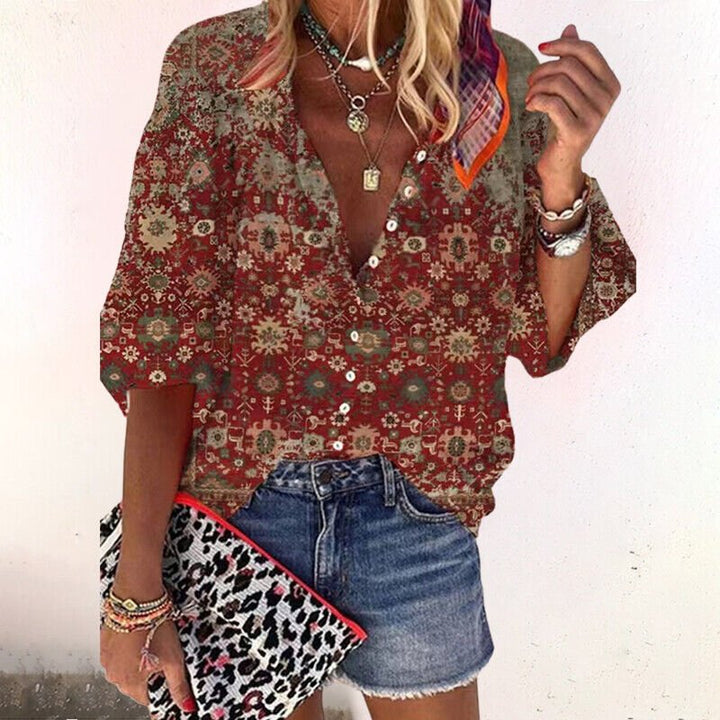 Vibrant floral print women's short sleeve blouse with a flattering v-neck and practical button-front design.
