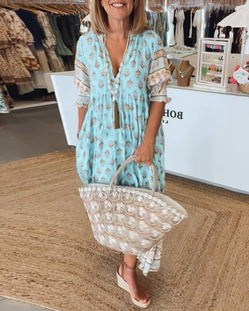 Women's Bohemian midi dress with lantern sleeves, V-neck, & pockets. Perfect for casual summer style.