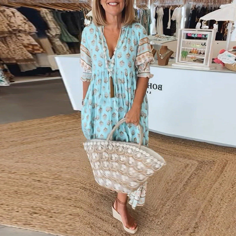 Chic women's bohemian midi dress with elegant lantern sleeves, comfortable flowy design, and useful pockets.