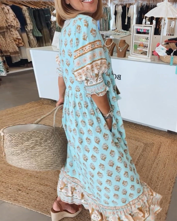 Flowy bohemian midi dress for women, featuring elegant lantern sleeves & practical pockets. Summer casual.
