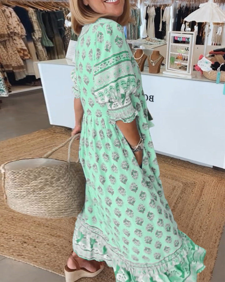 Bohemian women's midi dress, V-neck, and voluminous lantern sleeves. Ideal flowy summer wear with pockets.