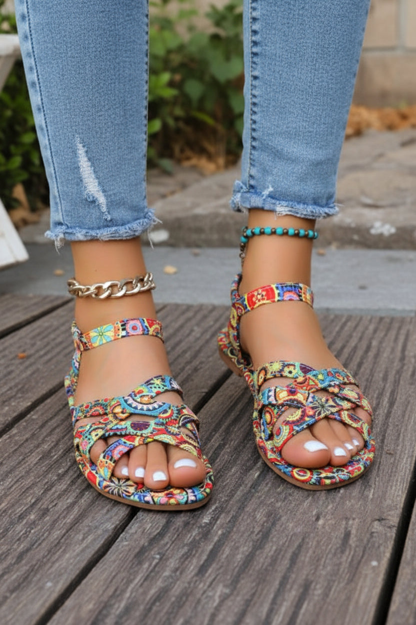 Close-up of women's bohemian print T-strap flat sandals. Enjoy summer comfort with these stylish open-toe shoes.