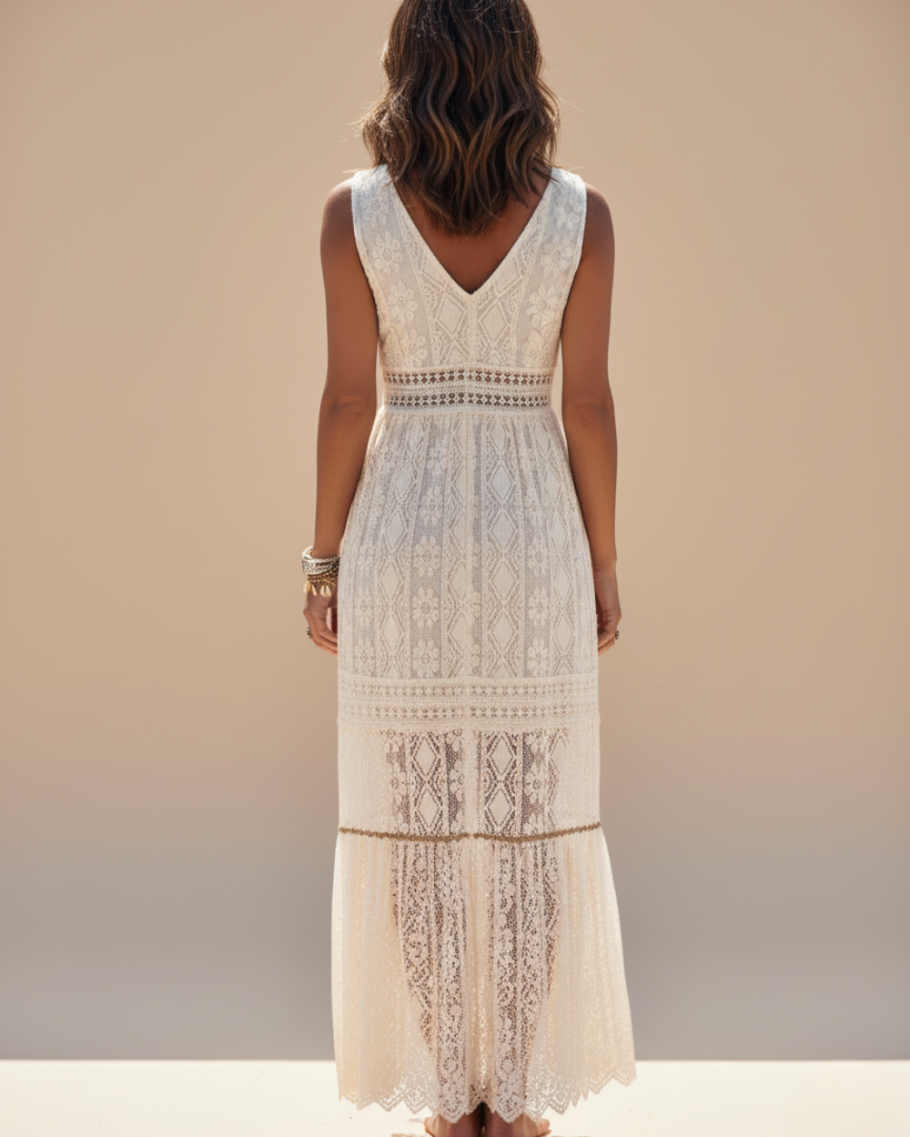 Flowy bohemian maxi dress for women featuring delicate crochet lace, V-neck, and chic tassels. Ideal for summer.
